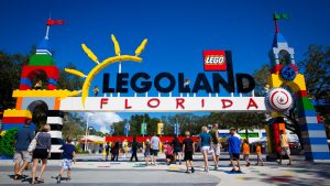 People walking through the colorful entrance to Legoland Florida